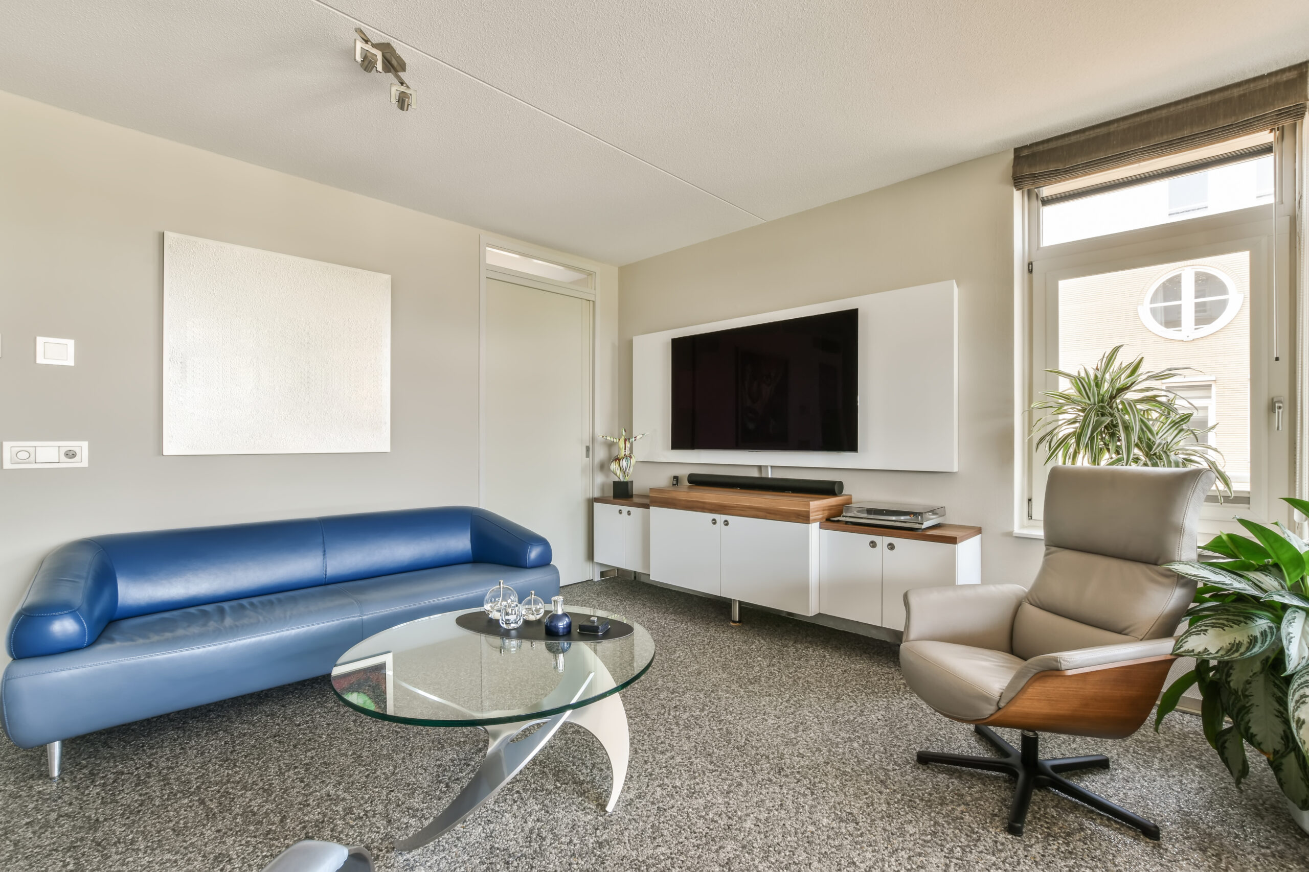 a living room with a blue couch and a table
