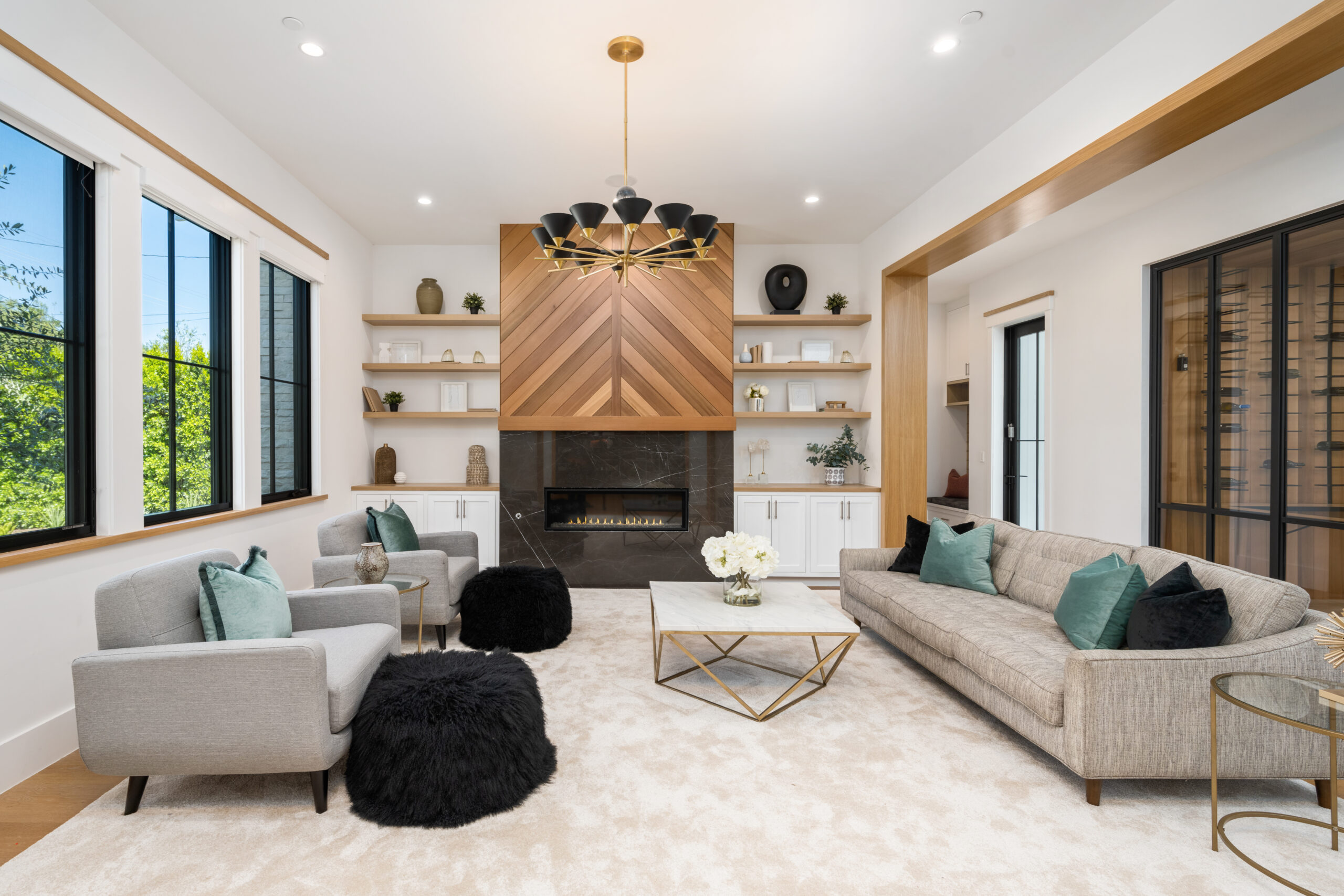 this living room has wooden walls and large windows with lots of natural light